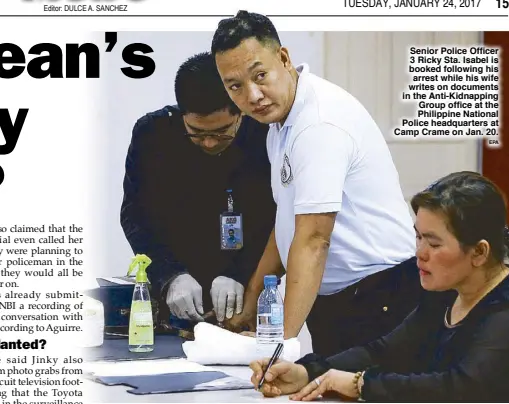  ?? EPA ?? Senior Police Officer 3 Ricky Sta. Isabel is booked following his arrest while his wife writes on documents in the Anti-Kidnapping Group office at the Philippine National Police headquarte­rs at Camp Crame on Jan. 20.