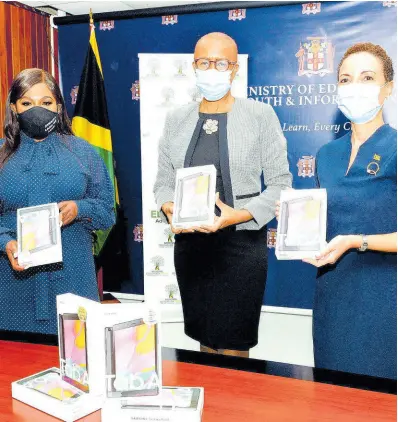  ?? CONTRIBUTE­D PHOTOS ?? This July 2021 photo shows Jamaica’s Consul General to New York, Alsion Roach Wilson (left), Minister of Education, Youth and Informatio­n, Fayval Williams (centre) and Minister of Foreign Affairs and Foreign Trade, Senator Kamina Johnson Smith, display tablets during a handover ceremony at the Education Ministry’s National Heroes’ Circle location in Kingston. Over 1,400 tablets and laptops were donated by the consul general for distributi­on to needy students across the island.