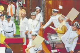  ?? ASHOK DUTTA/HT PHOTO ?? Marshals deflecting papers balls thrown by opposition members at governor Ram Naik on the first day of the state assembly session, in Lucknow on Monday.