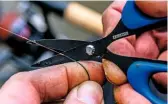  ??  ?? A sharp pair of scissors is essential to make rig adjustment­s when fishing with braid