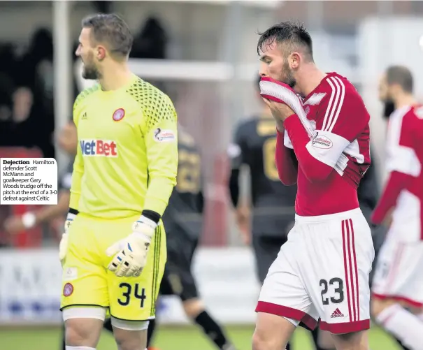  ??  ?? Dejection Hamilton defender Scott Mcmann and goalkeeper Gary Woods trudge off the pitch at the end of a 3-0 defeat against Celtic