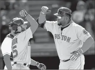  ?? TONY DEJAK/THE ASSOCIATED PRESS ?? Boston’s David Ortiz, right, is greeted by Dustin Pedroia after hitting a two-run home in the ninth inning of a victory over the Indians in Cleveland on Tuesday afternoon.