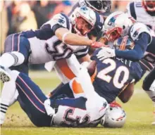  ??  ?? Devin McCourty, on the ground, Rob Ninkovich (50) and Logan Ryan of the New England Patriots stop Broncos running back Justin Forsett during the second quarter. John Leyba, The Denver Post