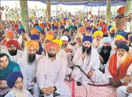  ?? HT PHOTO ?? Sikh preacher Baljit Singh Daduwal addresses the gathering as other religious leaders and AAP MLAs, including leader of opposition Sukhpal Singh Khaira, look on, at Bargari in Faridkot on Saturday.