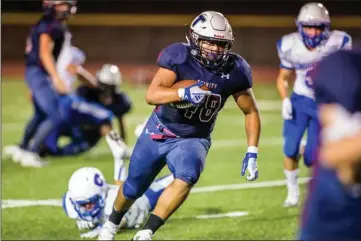  ?? Photo courtesy Wally Caddow ?? (Above) Trinity Classical Academy’s Jacob Estanol (48) carries the ball in Trinity’s 38-0 win over Desert Christian on Friday at Fillmore High School. (Below) Carson Campuzano (4) scores for Trinity.