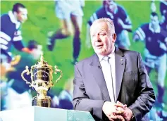  ?? Photo — AFP ?? World Rugby Chairman Bill Beaumont speaks beside the Webb Ellis Cup before the Rugby World Cup 2019 match schedule announceme­nt in Tokyo on November 2, 2017.