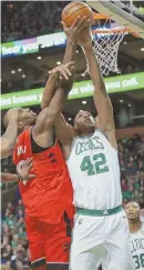  ?? STAFF PHOTO BY MATT WEST ?? BLOCK PARTY: Celtics forward Al Horford stuff’s Toronto’s Serge Ibaka during the first half of yesterday’s 95-94 victory at the Garden.