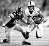  ?? JEFF ROBERSON/ASSOCIATED PRESS ?? Penn State’s Saquon Barkley, who may be rising in the Heisman race, evades Iowa’s Anthony Nelson on Saturday.