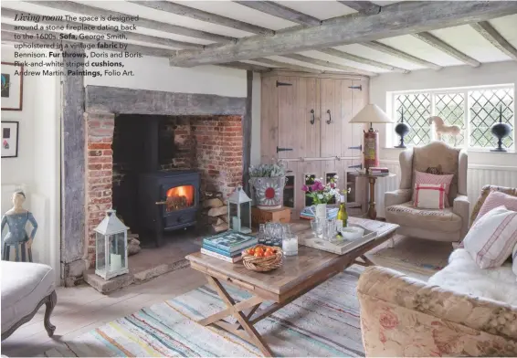  ??  ?? Living room The space is designed around a stone fireplace dating back to the 1600s. Sofa, George Smith, upholstere­d in a vintage fabric by Bennison. Fur throws, Doris and Boris. Pink-and-white striped cushions, Andrew Martin. Paintings, Folio Art.