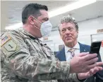  ?? SUSAN WALSH THE ASSOCIATED PRESS ?? Sen. Rand Paul, posing with a guardsman in Washington on Friday, once suffered injuries in an attack and had part of a lung removed. He knows violence is no cartoon, Heather Mallick writes.