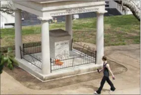  ?? PHOTOS BY ERIK SCHELZIG — ASSOCIATED PRESS ?? A visitor looks at the burial place of President James K. Polk and his wife, Sarah Polk, on the grounds of the state Capitol in Nashville, Tenn., on Friday, March 24, 2017. A resolution being considered in the state Legislatur­e calls for exhuming their...