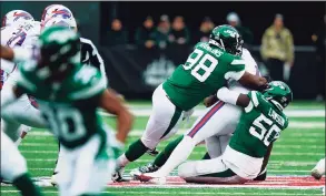  ?? Frank Franklin II / Associated Press ?? The New York Jets’ Shaq Lawson, right, and Sheldon Rankins sack Buffalo Bills quarterbac­k Josh Allen during the first half on Nov. 14.