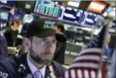  ?? RICHARD DREW — THE ASSOCIATED PRESS ?? Specialist Michael Pistillo wears a “Dow 26,000” hat as he works on the floor of the New York Stock Exchange, Wednesday. A broad rally on Wall Street propelled the Dow Jones industrial average to close above 26,000 points for the first time Wednesday.