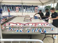  ?? Photo by Brendan McGair ?? Staff members from Montilo’s Baking cut pieces of a giant birthday cake for Patriots quarterbac­k Tom Brady at Gillette Stadium on Friday. Brady turned 41.