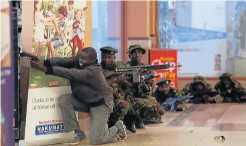  ?? REUTERS ?? Soldiers and armed police hunt gunmen who went on a shooting spree in Westgate shopping centre in Nairobi on Saturday. The gunmen stormed the mall killing at least 68 people.