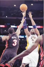  ?? Mark J. Terrill/associated Press ?? The Lakers’ Kobe Bryant shoots over the Heat’s Dwyane Wade, who broke Bryant’s nose with a hard foul in the AllStar Game. Wade had 16 points before fouling out.