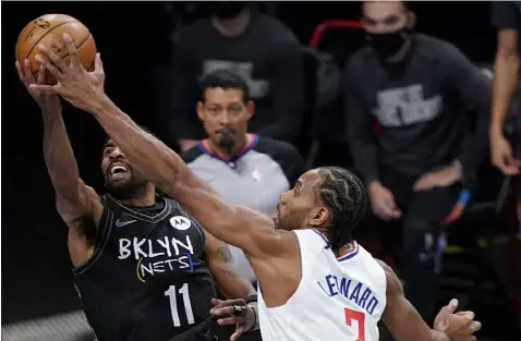  ?? Los Angeles Clippers forward Kawhi Leonard (2) defends against Brooklyn Nets guard Kyrie Irving (11) during the first quarter of an NBA basketball game Tuesday, Feb. 2, 2021, in New York. (AP Photo/Kathy Willens) ??