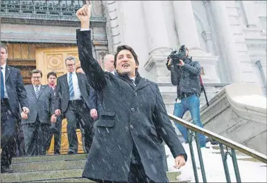  ?? CP PHOTO ?? Prime Minister Justin Trudeau gives a thumbs up to protesters following his meeting with Montreal Mayor Denis Coderre in Montreal Tuesday.