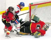  ?? DARREN MAKOWICHUK ?? Calgary Inferno goaltender Lindsey Post makes a save on Les Canadienne­s’ Ann-Sophie Bettez earlier this season.