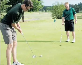  ?? Bruce Edwards/Edmonton Journal ?? University of Alberta golf coach Robin Stewart watches Tom Fuhr practice putting in June.