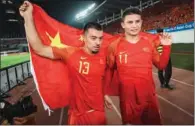  ?? (AFP) ?? A file photo taken on October 10, 2019 shows China’s Li Ke (left) and Brazilian-born Elkeson (both naturalise­d players now representi­ng China) celebratin­g after winning the 2022 Football World Cup qualifier between China and Guam in Guangzhou.