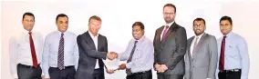  ??  ?? Third from left Vice President Microsoft Asia Pacific István Papp exchanges agreement with Singer Group CEO Asoka Pieris. Also in the picture from left Singer Director – Marketing & Commercial Mahesh Wijewarden­e, Marketing Manager – Electronic­s &...