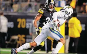  ?? [DON WRIGHT/THE ASSOCIATED PRESS] ?? Chargers wide receiver Keenan Allen (13) gets past Steelers strong safety Terrell Edmunds (34) after making a catch to take it in for a touchdown Sunday in Pittsburgh.