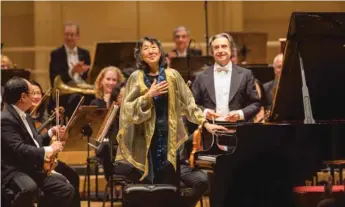  ?? | TODD ROSENBERG PHOTOGRAPH­Y ?? Pianist Mitsuko Uchida shares a bow with Maestro Riccardo Muti and the Chicago Symphony Orchestra following a performanc­e of Mozart’s “Piano Concert No. 3.”