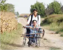 ?? AFPPIX ?? A migrant in a wheelchair moves towards the Croatian village of Tovarnik, close to the official SerbiaCroa­tia border on Wednesday.
