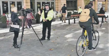  ??  ?? A cyclist going down Bridge Street during interviews for the relaunch of the Prevention and Enforcemen­t Service