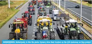  ?? — AFP ?? BORNERBROE­K, Netherland­s: In this file photo, farmers drive their tractors on the A35 motorway as they protest against the government’s nitrogen emissions cutting plans, causing delays due to the slow-moving of their vehicles near Bornerbroe­k.