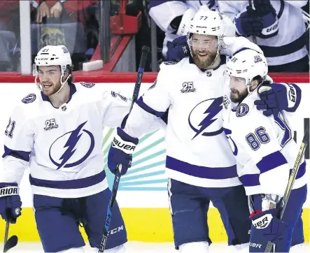  ?? PATRICK SMITH/GETTY IMAGES ?? Lightning forward Nikita Kucherov, right, celebrates a goal with teammates Brayden Point, left, and Victor Hedman on Tuesday as Tampa Bay won 4-2 in Game 3 of the Eastern Conference final in Washington, D.C., to cut the Capitals’ series lead to 2-1.