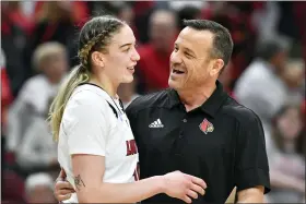  ?? TIMOTHY D. EASLEY — THE ASSOCIATED PRESS ?? Louisville head coach Jeff Walz, right, talks with forward Emily Engstler (21) during a timeout in the second half of their women’s NCAA tournament college basketball secondroun­d game in Louisville, Ky., Sunday, March 20, 2022.