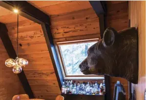  ??  ?? BOTTOM RIGHT: CURTIS’ WIFE FOUND THE CARVED BEAR, WHICH IS FITTING FOR THE CABIN’S LOCATION. (A GRIZZLY BEAR IS THE OFFICIAL STATE ANIMAL OF CALIFORNIA.)