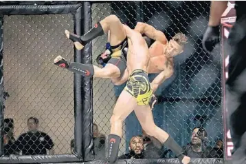  ??  ?? Damien Martinez picks up and slams his opponent Roy Echeverria during XFN 20 in Fort Lauderdale on June 9.