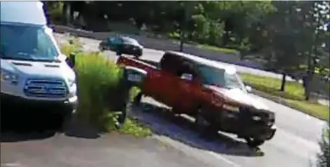  ?? SURVEILLAN­CE IMAGE ?? This image released by West Goshen Police shows the red pickup truck believed involved in fatal road rage shooting in Chester County. Police said the truck was spotted driving on Route 352into Delaware County.