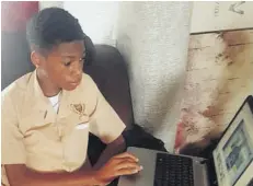  ??  ?? Kimani Mcleish, a grade seven student at Muschett High School, logs in to his virtual class from his home in Florence Hall Village, Trelawny.