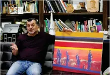  ?? Reuters ?? Palestinia­n Abdelfatta­h Abusrour shows his painting at his office in Aida refugee camp, Bethlehem, in the Israeli-occupied West Bank.