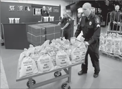  ??  ?? OHIO RESIDENTS CASH IN: It’s like a modern day Gold Rush. Everyone’s scrambling to get their hands on the heavy, Jumbo Silver Ballistic Bags pictured above before they’re all gone. That’s because residents who find their zip code printed in today’s publicatio­n are cashing in on the lowest ever State Minimum price set for the next 2 days by the Federated Mint.