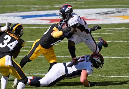  ?? AP Photo/Don Wright ?? Denver Broncos running back Royce Freeman (28) is tackled by Pittsburgh Steelers outside linebacker T.J. Watt (90) during the first half of NFL football game in Pittsburgh, on Sunday.