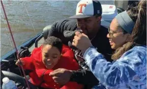  ?? (Photo courtesy of Katherine Malca) ?? Eli Coats smiles while on a fishing trip with his parents, Justin Coats and Katherine Malca. A medication helps slow the progressio­n of Eli’s rare genetic condition, Aicardi-goutieres Syndrome.