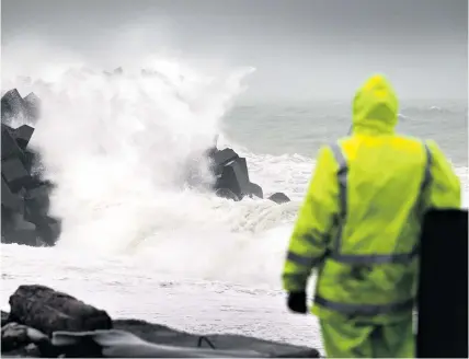  ?? Picture/ NZME ?? Brent Stringer looks at the big swell hitting the Napier Port breakwater yesterday.