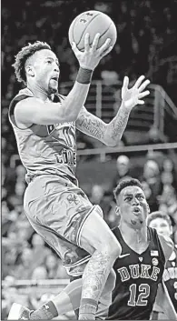  ?? AP/MICHAEL DWYER ?? Boston College’s Ky Bowman shoots in front of Duke’s Javin DeLaurier during the first half Saturday in Boston. The unranked Eagles upset the top-ranked Blue Devils 89-84.