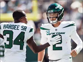  ?? Adam Hunger / Associated Press ?? Jets defensive back Justin Hardee (34) consoles quarterbac­k Zach Wilson during Sunday’s loss to the Patriots in East Rutherford, N.J.