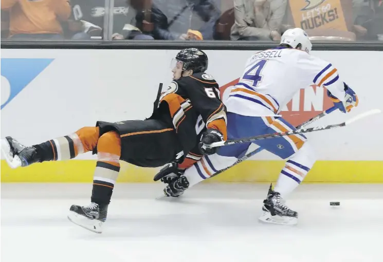  ?? CHRIS CARLSON/THE ASSOCIATED PRESS ?? Oilers defenceman Kris Russell vies for the puck Friday night with Anaheim Ducks centre Rickard Rakell during the first period of Game 2 in their second-round playoff series in Anaheim. The Oilers won 2-1 to take a 2-0 series lead.