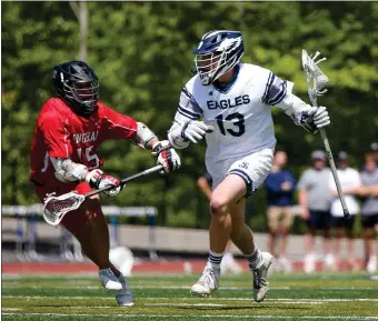  ?? PHOTO BY REBA SALDANHA — BOSTON HERALD ?? St. John’s Prep’s Jake Vana and Hingham’s Chase McKenna battle Saturday in a boys lacrosse game. Vana scored 4 goals.