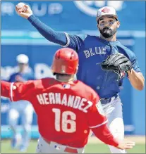  ?? CP PHOTO ?? Toronto Blue Jays second baseman Devon Travis forces out Philadelph­ia Phillies’ Cesar Hernandez at second and relays the throw to first base in time to turn a double play on Rhys Hoskins during a spring training game Wednesday in Dunedin, Fla.