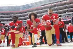  ?? — AP ?? SANTA CLARA: San Francisco 49ers outside linebacker Eli Harold, quarterbac­k Colin Kaepernick and safety Eric Reid kneel during the national anthem before an NFL football game against the Dallas Cowboys.