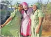  ??  ?? MPUME Buthelezi and Busi Khoza with Christina Ray Stanton. She wears a handsewn dress they made for her to mark their 10-year friendship.