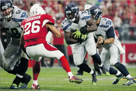  ?? — PHOTOS: GETTY IMAGES ?? Seattle Seahawks running back Christine Michael, second from right, rushed for 102 yards, while quarterbac­k Russell Wilson, right, threw for three touchdowns in the Seahawks’ 36-6 pasting of the Arizona Cardinals Sunday in Glendale, Ariz.